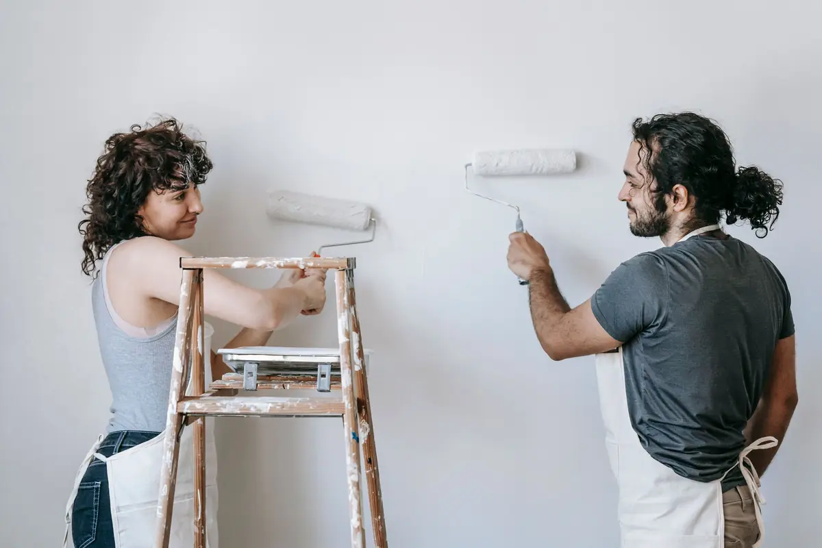 People painting a wall together — painting help in Wilmington